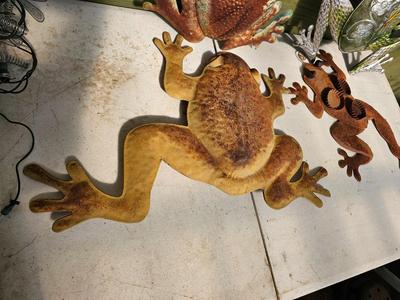 Four metal garden frogs and a strand of dragonfly lights