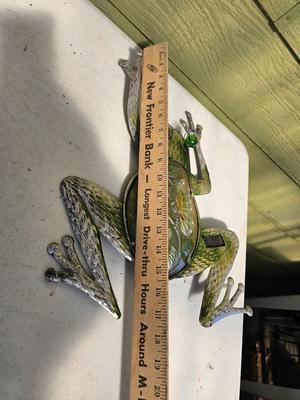 Four metal garden frogs and a strand of dragonfly lights