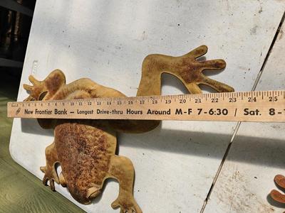 Four metal garden frogs and a strand of dragonfly lights