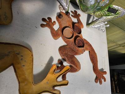 Four metal garden frogs and a strand of dragonfly lights
