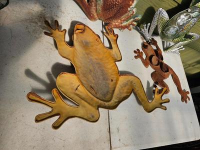 Four metal garden frogs and a strand of dragonfly lights