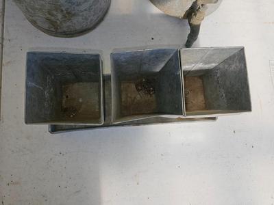 Galvanized watering can, waterer with a pout, and three herb pots with a tray