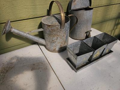 Galvanized watering can, waterer with a pout, and three herb pots with a tray