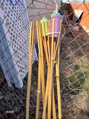 Four metal tiki torches - Bamboo torches with a jug of tiki fuel