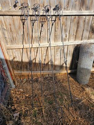 Four metal tiki torches - Bamboo torches with a jug of tiki fuel