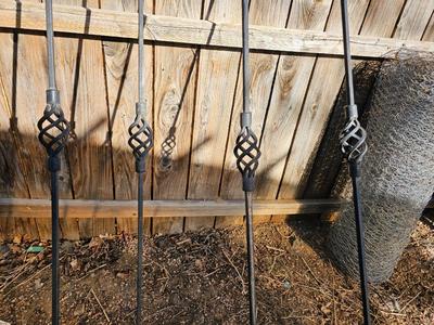 Four metal tiki torches - Bamboo torches with a jug of tiki fuel