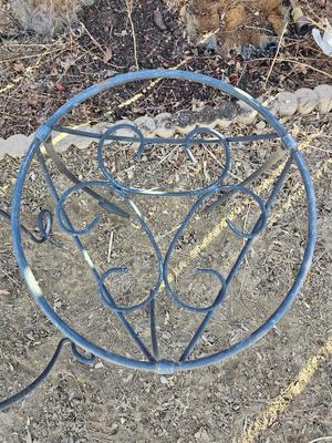 Two matching black metal plant stands