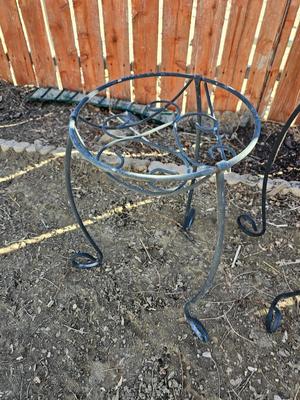 Two matching black metal plant stands