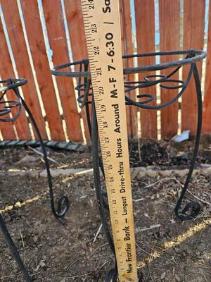 Two matching black metal plant stands