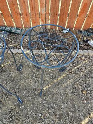 Two matching black metal plant stands