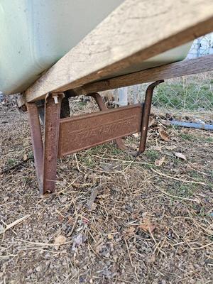 Large sized plastic wheelbarrow with a poop scooper and small rake