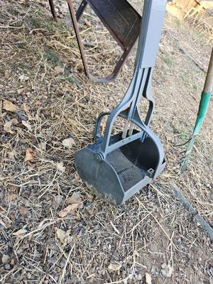Large sized plastic wheelbarrow with a poop scooper and small rake