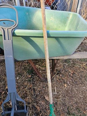 Large sized plastic wheelbarrow with a poop scooper and small rake