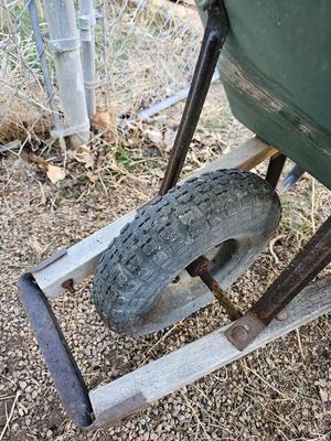 Large sized plastic wheelbarrow with a poop scooper and small rake