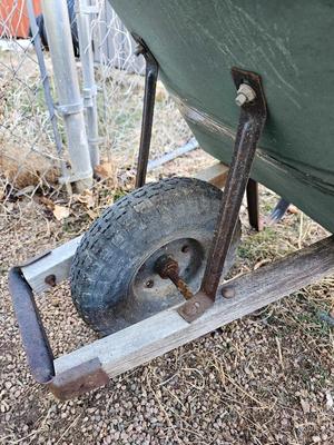 Large sized plastic wheelbarrow with a poop scooper and small rake