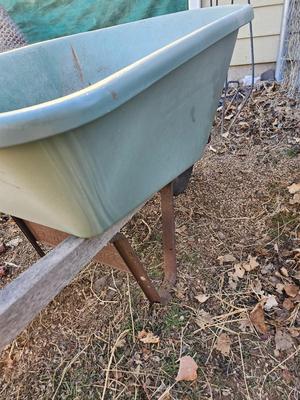 Large sized plastic wheelbarrow with a poop scooper and small rake