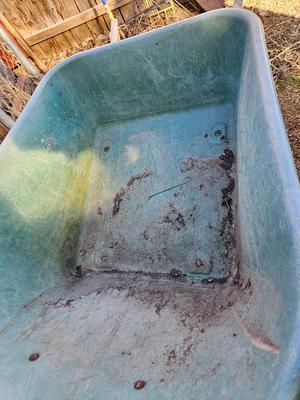 Large sized plastic wheelbarrow with a poop scooper and small rake