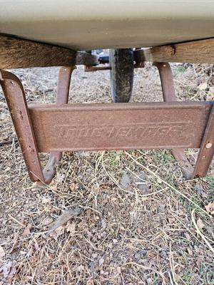 Large sized plastic wheelbarrow with a poop scooper and small rake