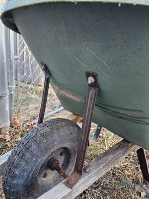 Large sized plastic wheelbarrow with a poop scooper and small rake