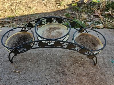 3 tiered plant stand with 3 terra cotta pots, small garden handtools, and watering can