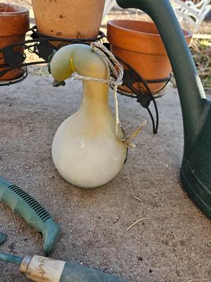 3 tiered plant stand with 3 terra cotta pots, small garden handtools, and watering can