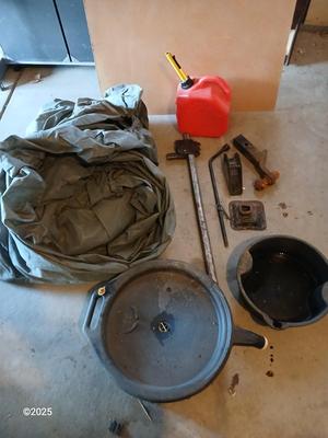 Auto cover with Jack, oil pans, gas can and a trailer hitch