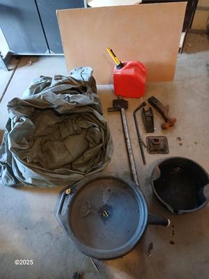 Auto cover with Jack, oil pans, gas can and a trailer hitch