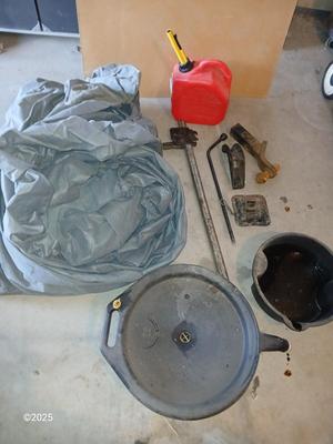 Auto cover with Jack, oil pans, gas can and a trailer hitch