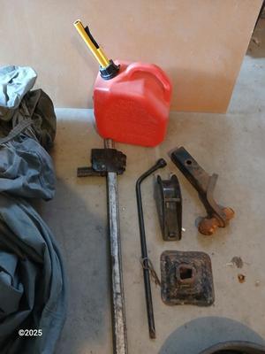 Auto cover with Jack, oil pans, gas can and a trailer hitch