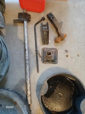 Auto cover with Jack, oil pans, gas can and a trailer hitch