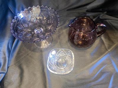 PURPLE PEDESTAL DISH, PITCHER, FOOTED CRYSTAL DISH AND DOILIES