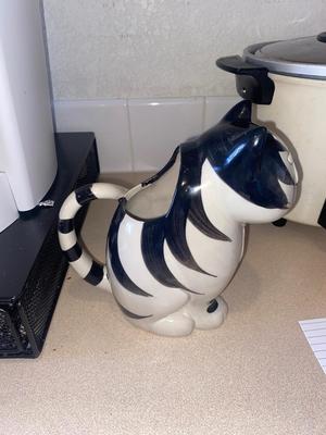 KEURIG COFFEE MAKER, KITTY CREAMER, AND TWO DIFFERENT COFFEE POD HOLDERS