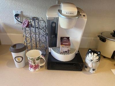 KEURIG COFFEE MAKER, KITTY CREAMER, AND TWO DIFFERENT COFFEE POD HOLDERS