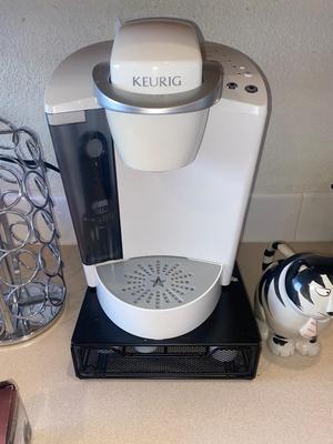 KEURIG COFFEE MAKER, KITTY CREAMER, AND TWO DIFFERENT COFFEE POD HOLDERS