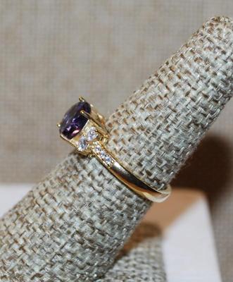 Size 7 Round Purple Stone Ring with Clear Stones Side Accents on a Gold Tone Band (2.4g)