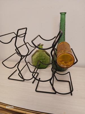 Three Unique glass bottles with two metal tabletop wine racks