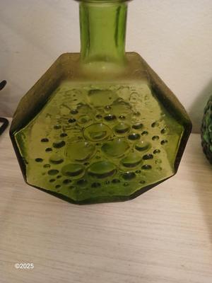 Three Unique glass bottles with two metal tabletop wine racks