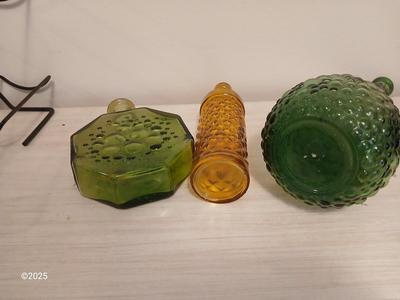 Three Unique glass bottles with two metal tabletop wine racks