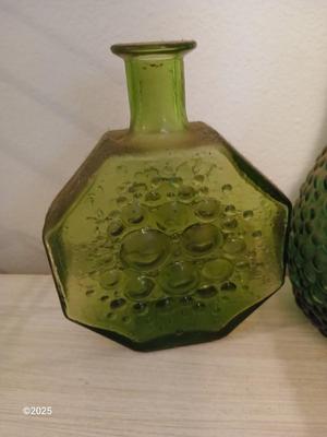 Three Unique glass bottles with two metal tabletop wine racks
