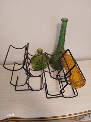 Three Unique glass bottles with two metal tabletop wine racks