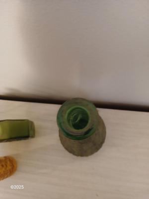 Three Unique glass bottles with two metal tabletop wine racks