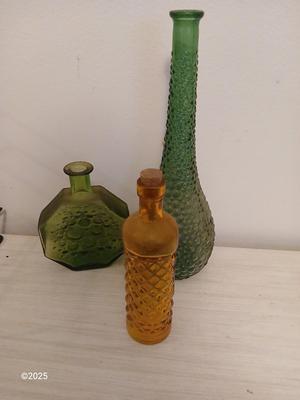 Three Unique glass bottles with two metal tabletop wine racks
