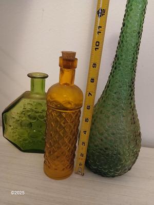 Three Unique glass bottles with two metal tabletop wine racks