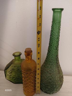 Three Unique glass bottles with two metal tabletop wine racks