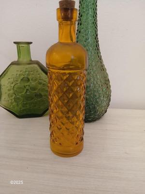 Three Unique glass bottles with two metal tabletop wine racks