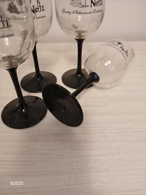 Eight wine glasses and two metal tabletop wine racks
