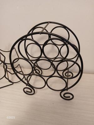 Eight wine glasses and two metal tabletop wine racks