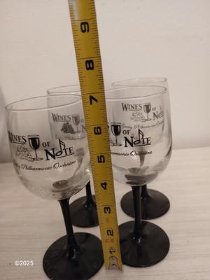 Eight wine glasses and two metal tabletop wine racks