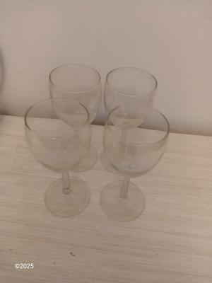 Eight wine glasses and two metal tabletop wine racks