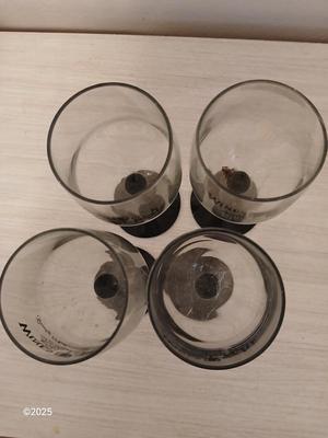 Eight wine glasses and two metal tabletop wine racks
